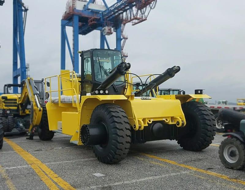 Another angle of a yellow forklift in a parking lot.
