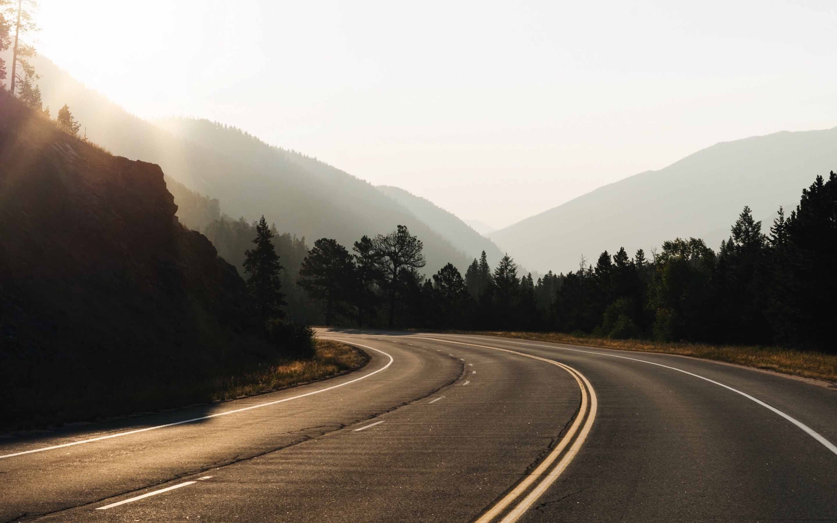 A winding, open road at sunrise.