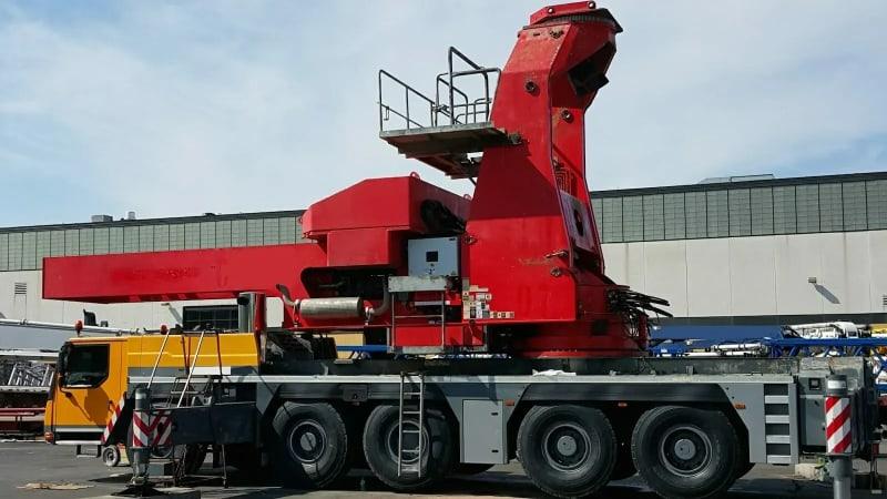 A close up of the red equipment for the dam project