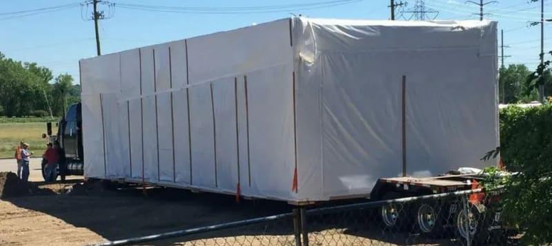 A close look at the prefabricated building on a truck.