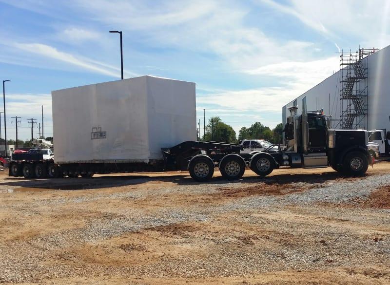 A section of a spiral freezer sits on a truck bed.