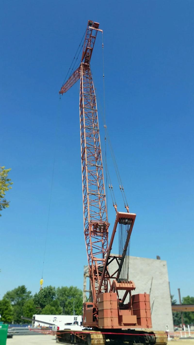 A red crane fully extended to show the height of the crane's arm.