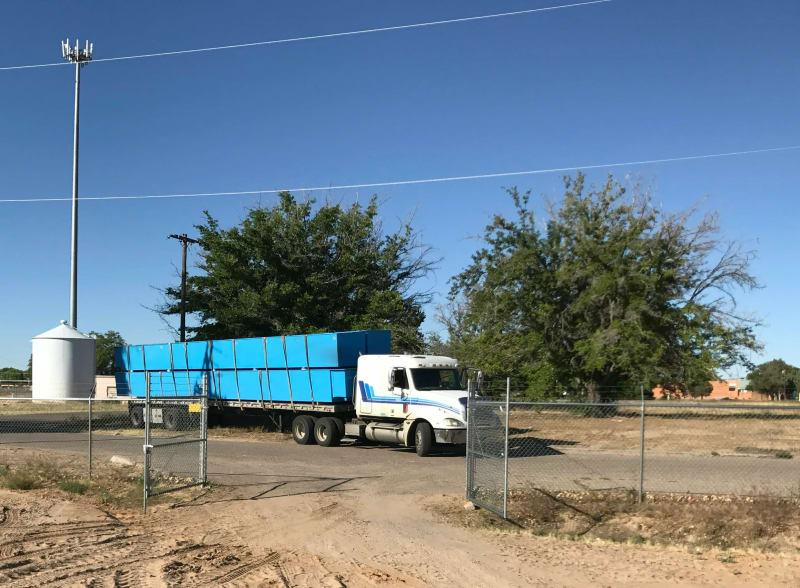 Fish farms loaded onto a truck in a parking lot