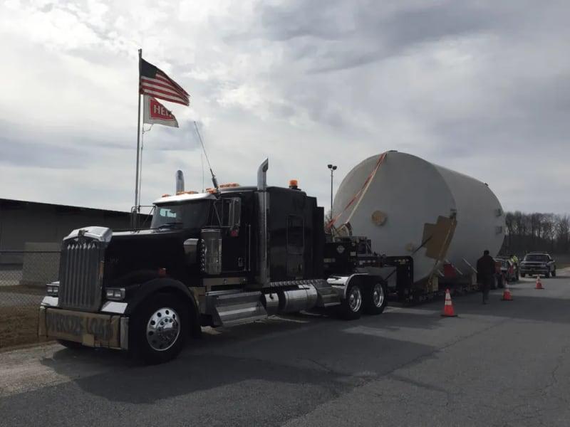 The front of the truck carrying a white fiberglass tank