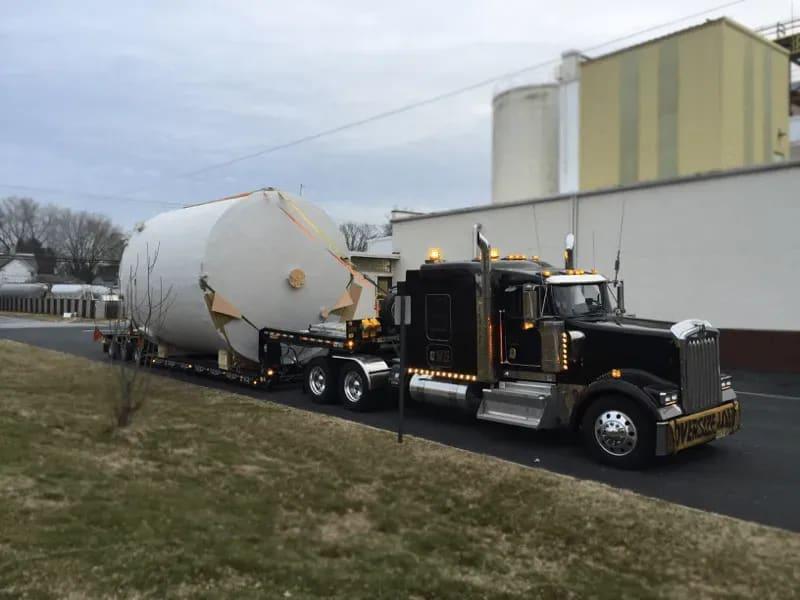 A fiberglass tank sitting on a truck in a parking lot