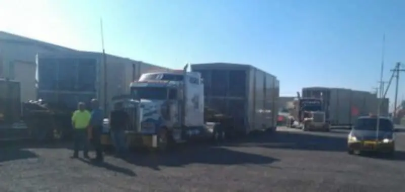 A generator loaded onto the back of a truck in a lot