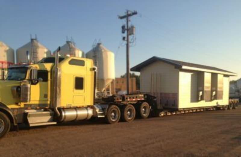 Prefabricated shelter on a truck bed.