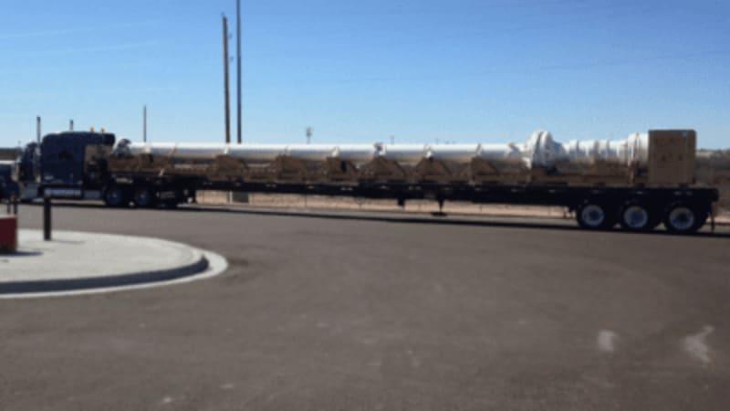 A telescopic joint for a drill ship sits on the bed of a long truck.