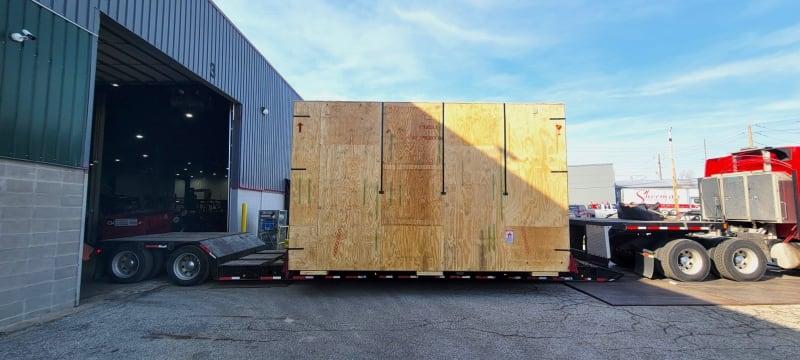 A crate loaded onto the back of a truck