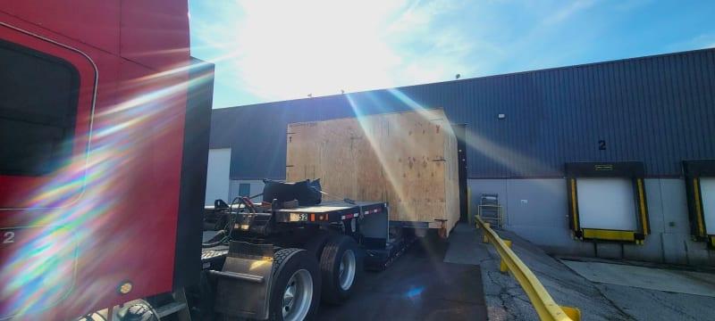 A large crate loaded onto a flat bed truck