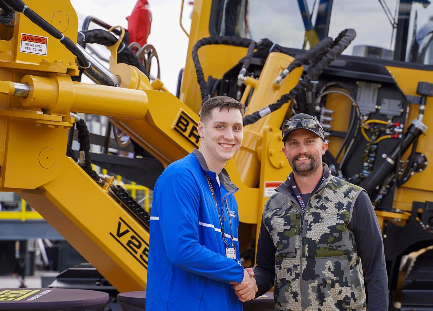 Two ZMac representatives smile together at an industry tradeshow.